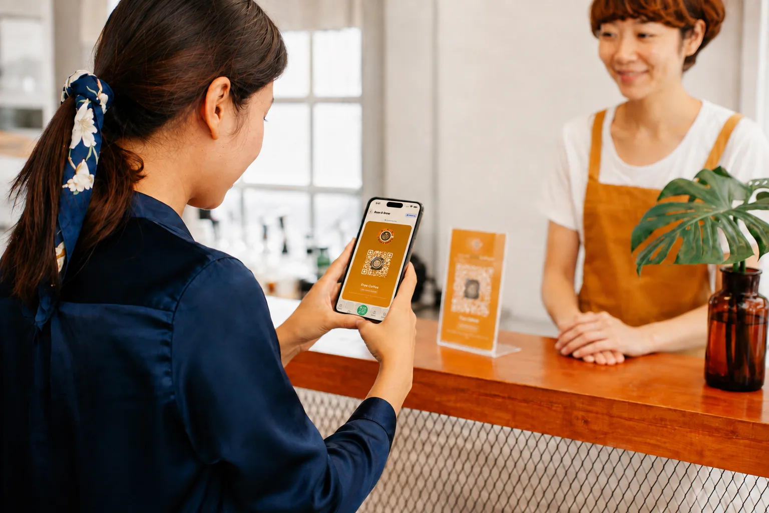 A customer viewing her newly installed Bean & Brew Free Coffee card in Sukify