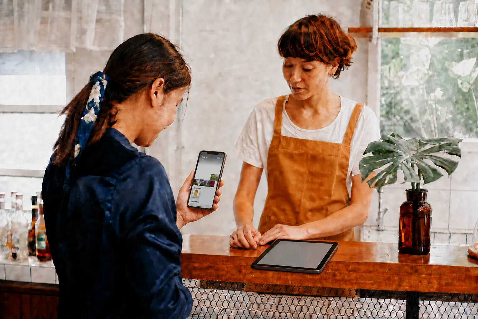 A customer viewing the saved Bean & Brew claim stub in her phone gallery